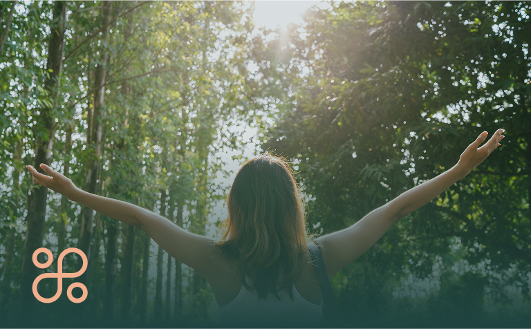woman holding hand up to sun